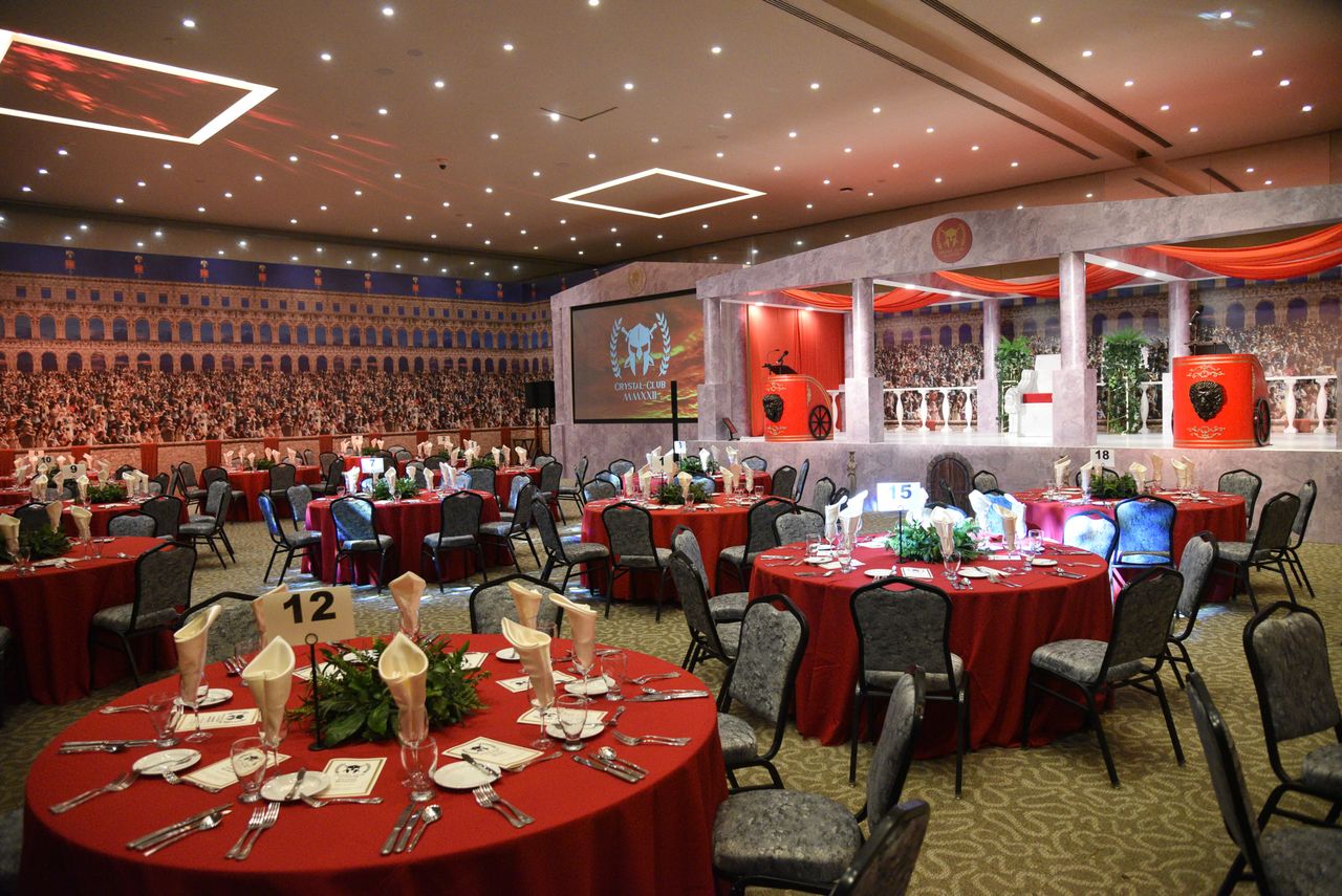 The Art of Drawing Readers In: Your attractive post title goes here Luxurious setup for a Roman-themed event with red table settings, ideal for formal dinners or parties.